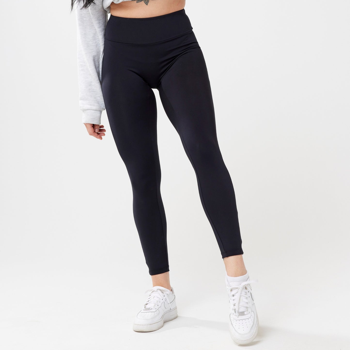 Model wearing black leggings for use in active lifestyles as well as casual living.