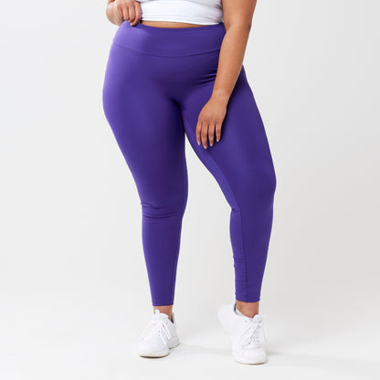 Plus model wearing indigo leggings for use in active lifestyles as well as casual living.