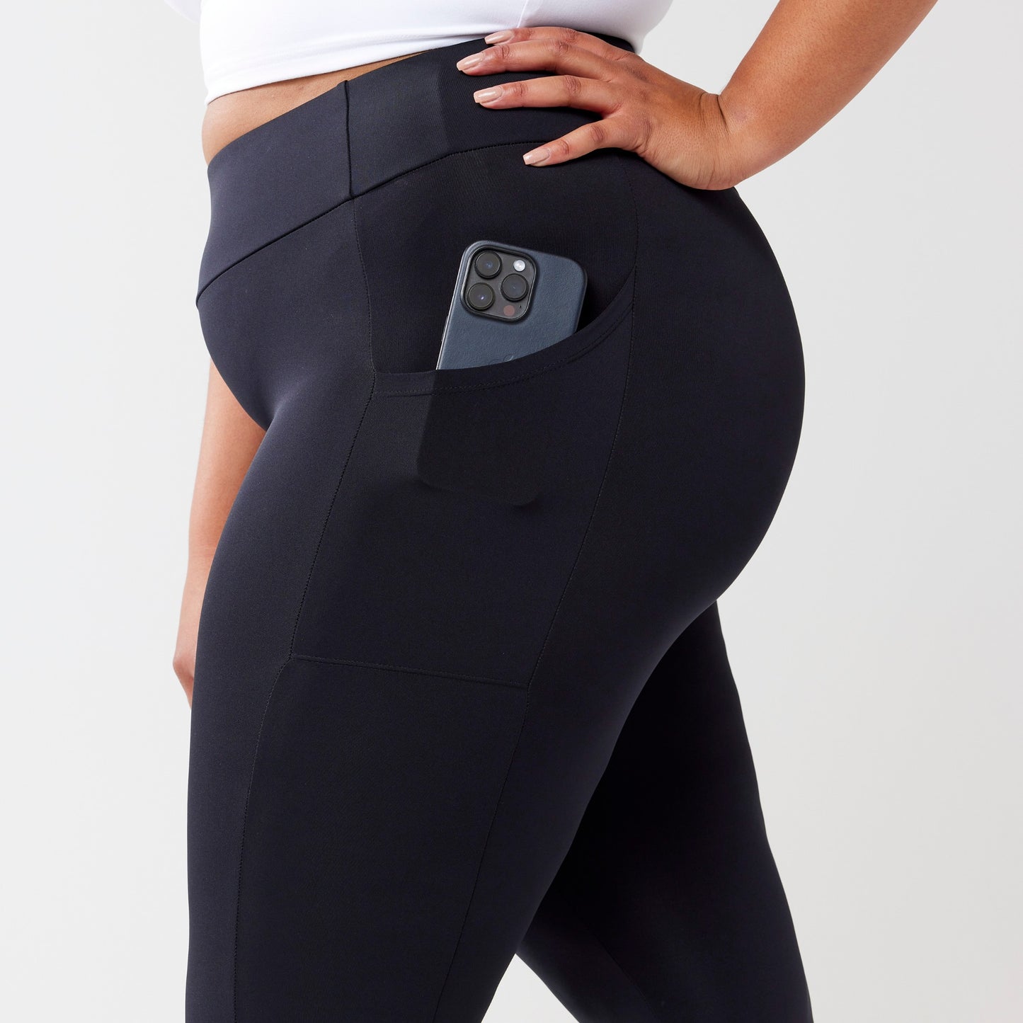 Plus model wearing black leggings for use in active lifestyles as well as casual living.