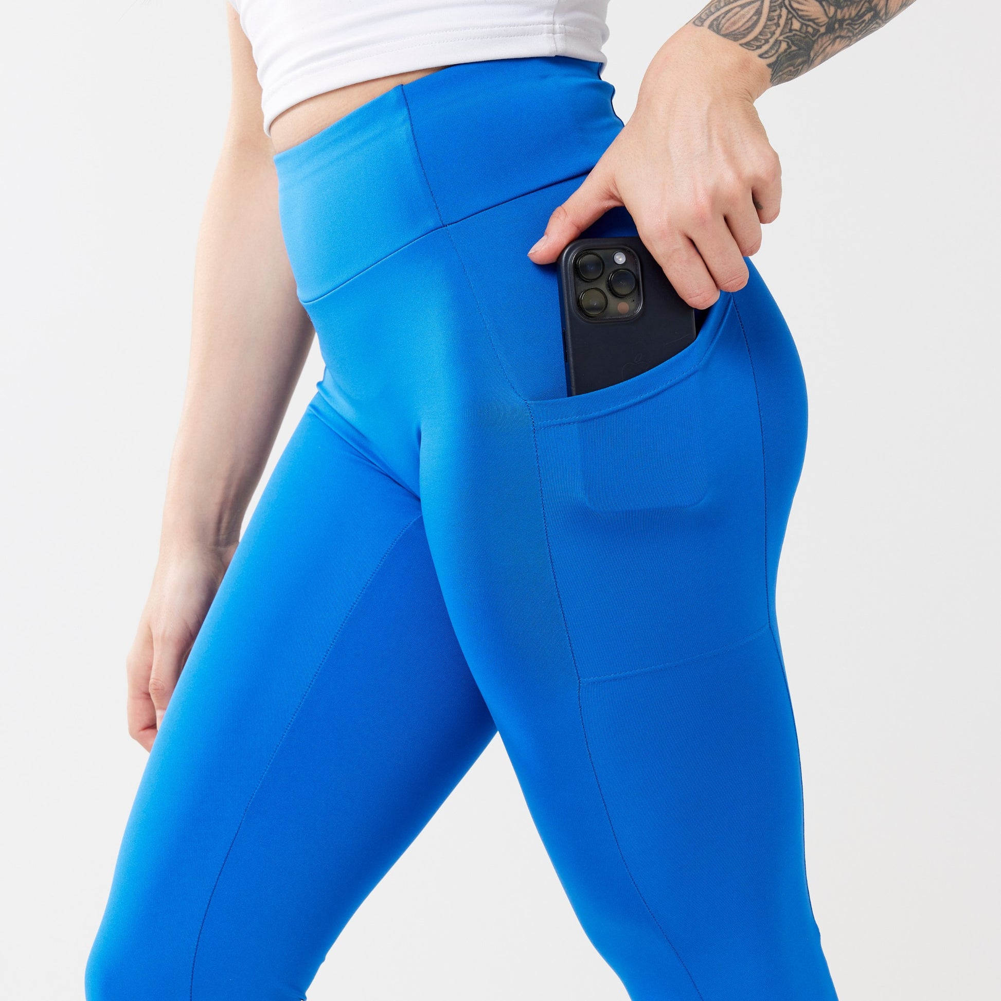 Model wearing cobalt leggings for use in active lifestyles as well as casual living.