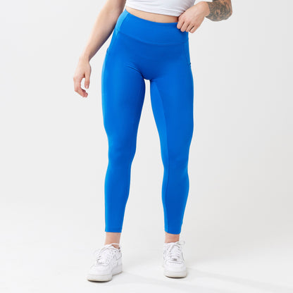 Model wearing cobalt leggings for use in active lifestyles as well as casual living.