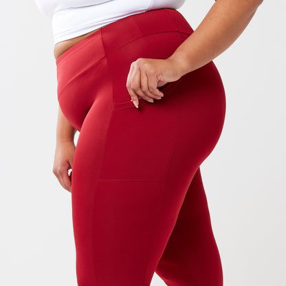 Plus model wearing red leggings for use in active lifestyles as well as casual living.