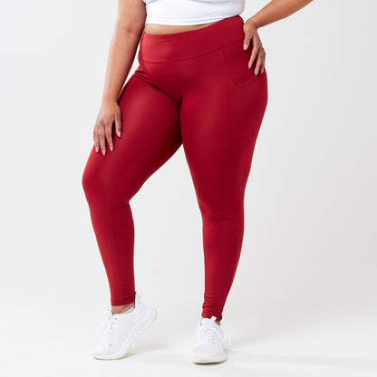 Plus model wearing red leggings for use in active lifestyles as well as casual living.