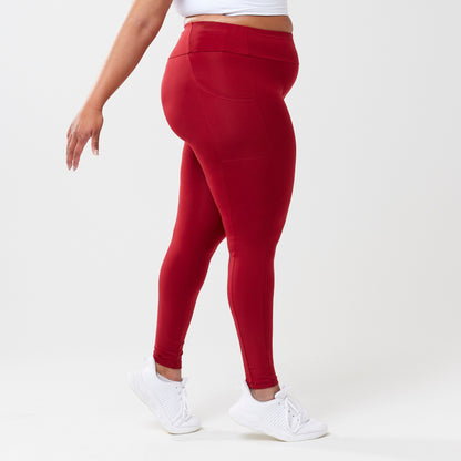 Plus model wearing red leggings for use in active lifestyles as well as casual living.