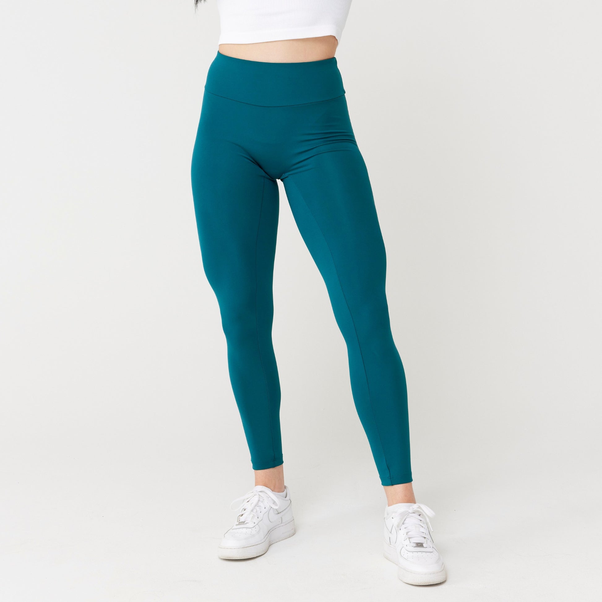 Model wearing rich teal leggings for use in active lifestyles as well as casual living.