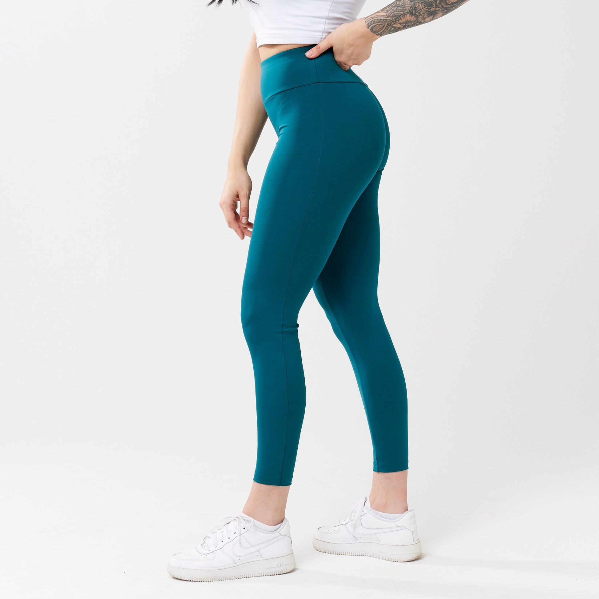 Model wearing rich teal leggings for use in active lifestyles as well as casual living.